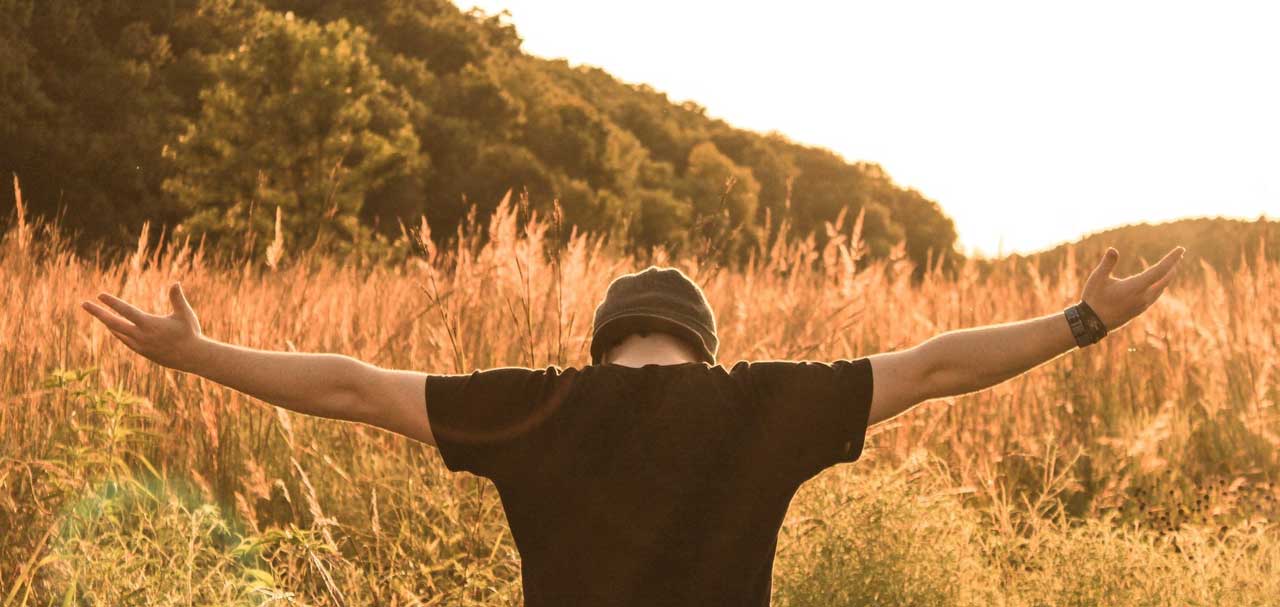 man standing in the middle of field