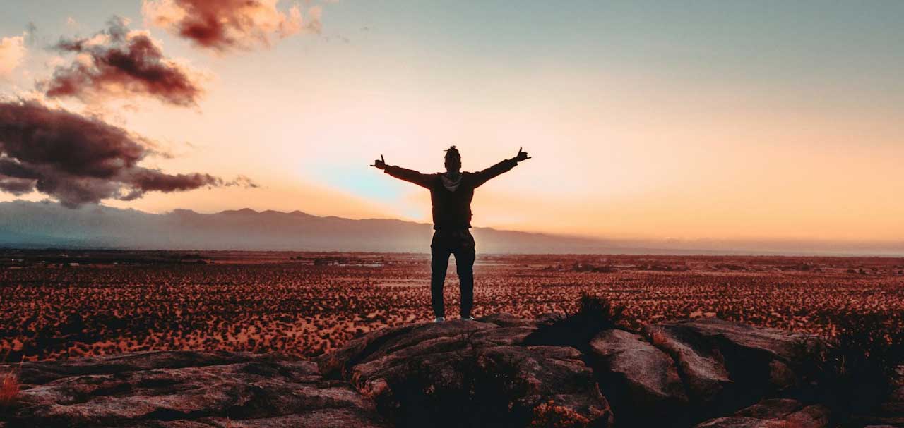 man standing in the middle of field